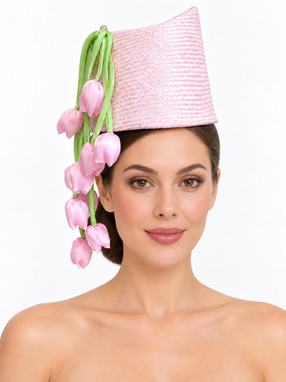 Model wearing a pink Parisisal straw hat with satin tulips