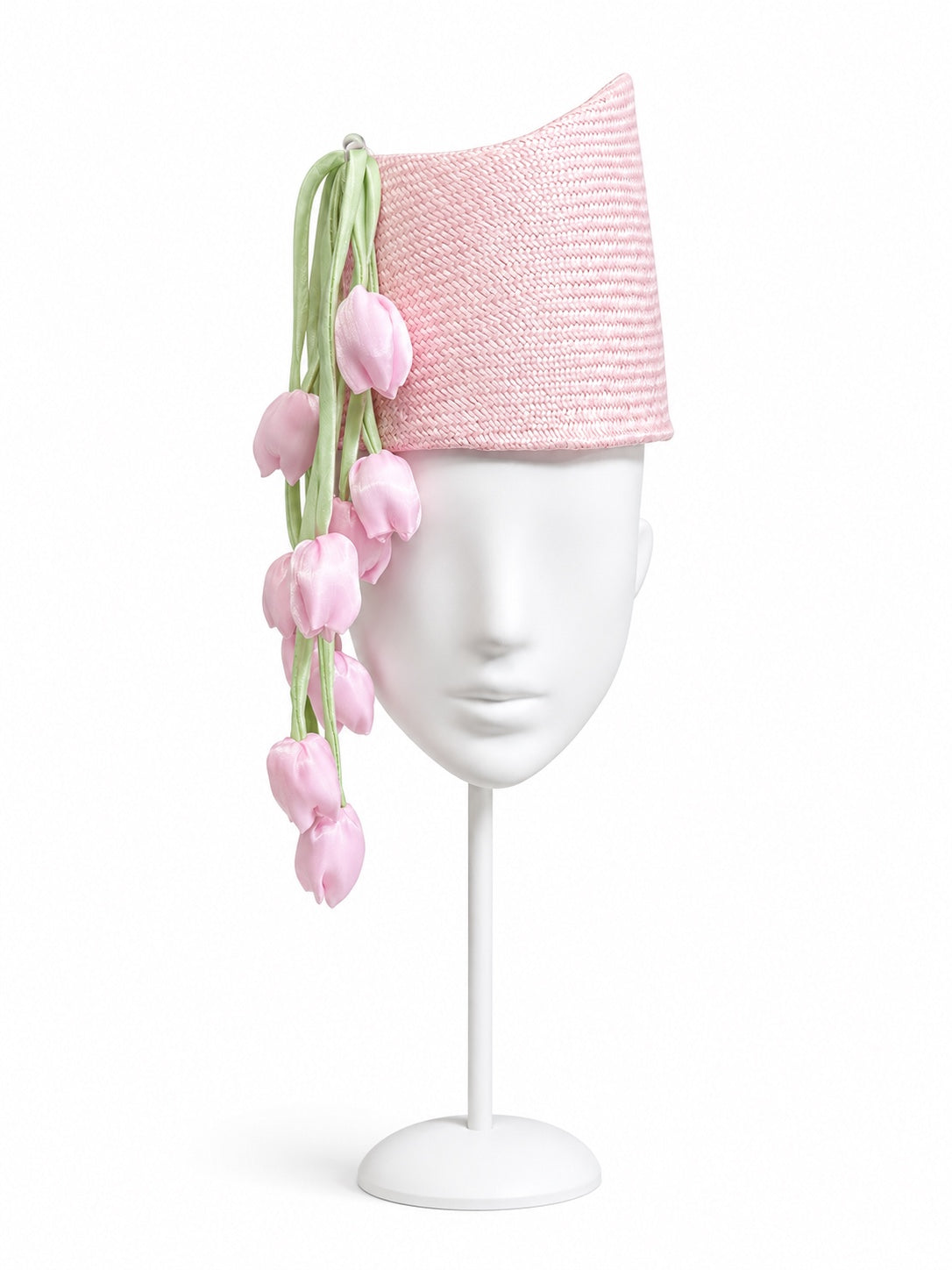Pink Parisisal straw crown with satin tulips and ties displayed on a mannequin