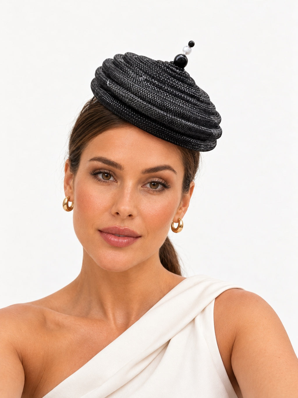 Onda Azzurra black sculptural spiral pillbox fascinator worn by a model