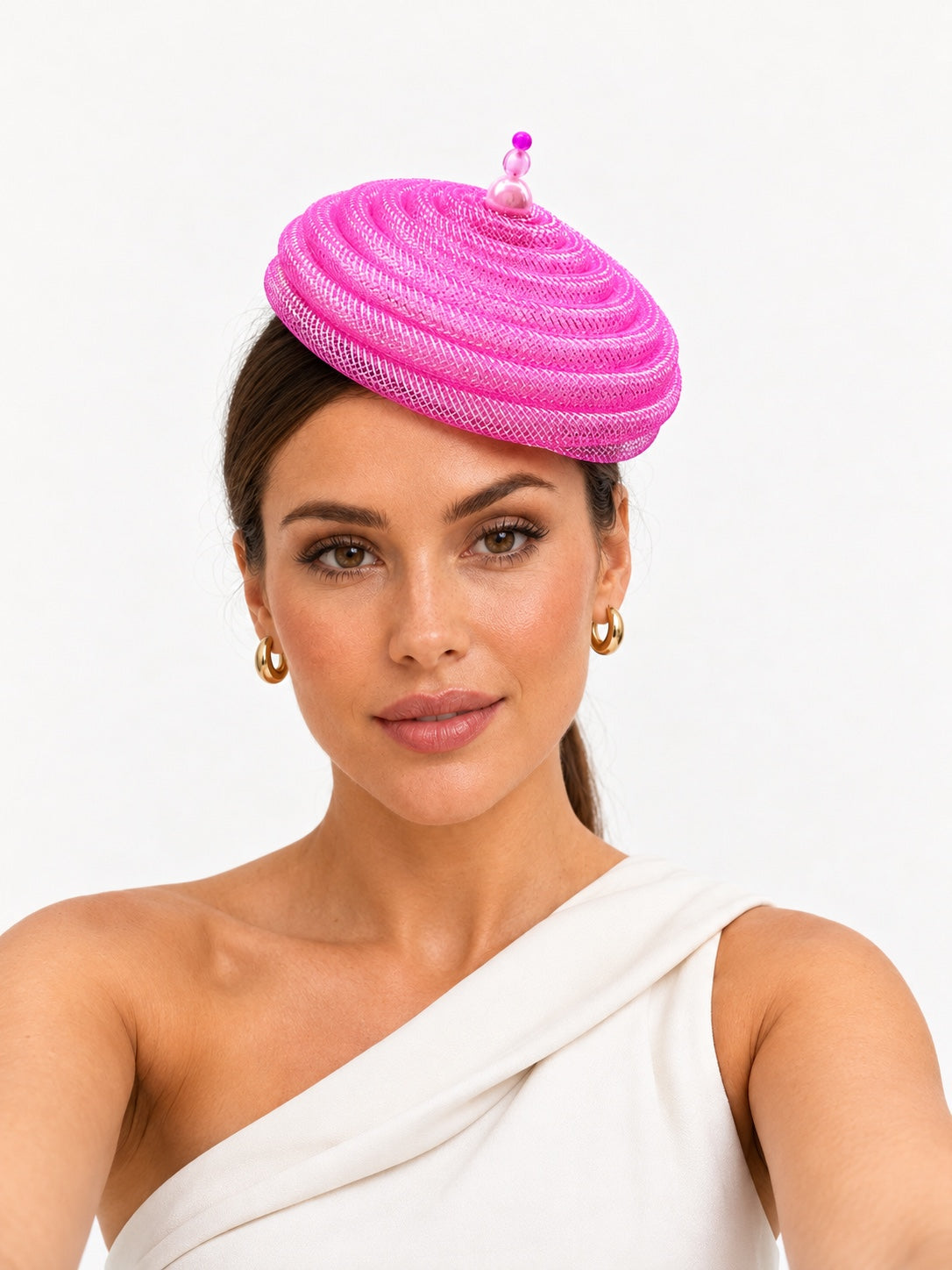 Onda Azzurra light pink sculptural spiral pillbox fascinator worn by a model