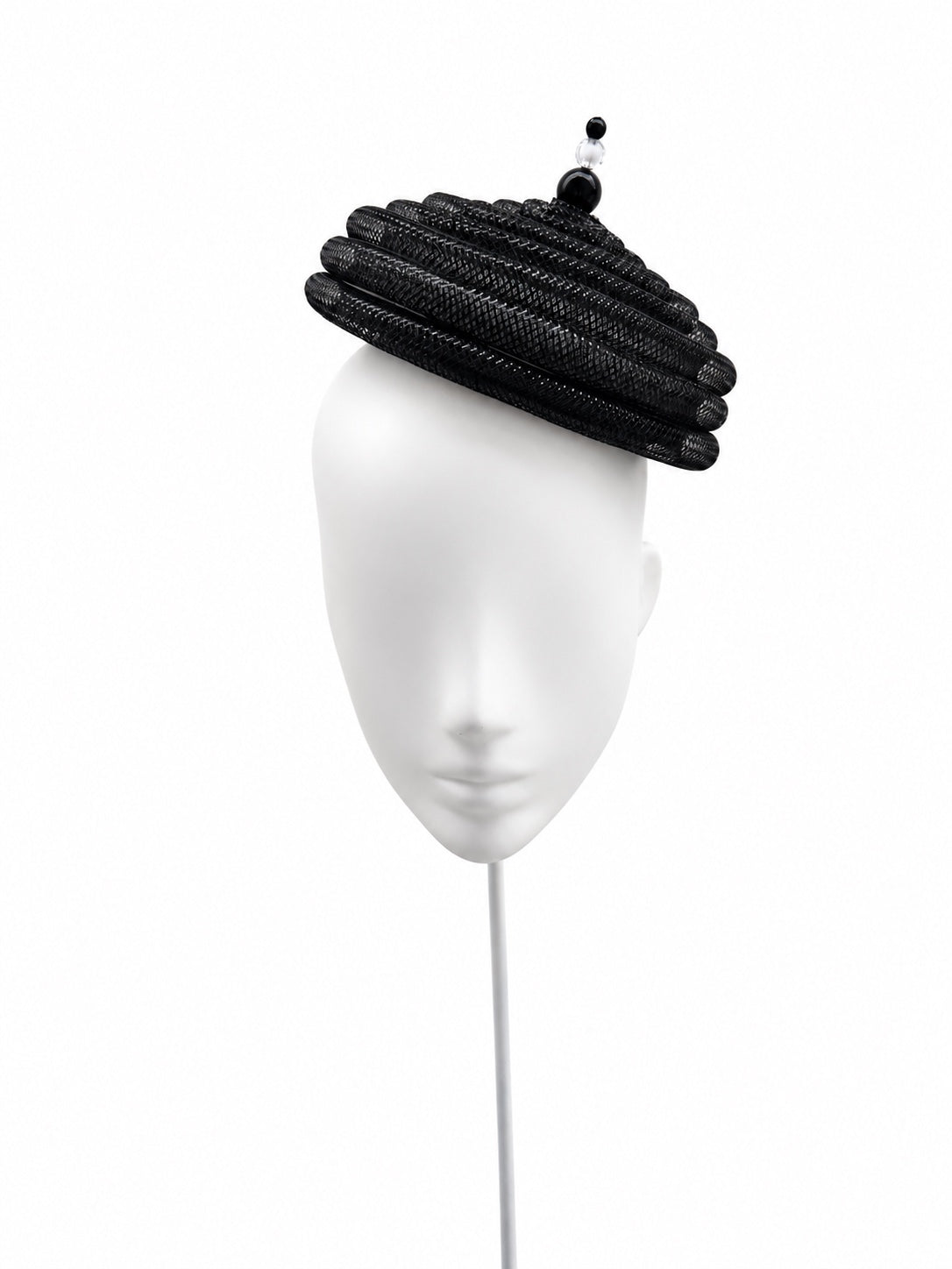 Onda Azzurra black sculptural spiral pillbox fascinator on a white mannequin, front view