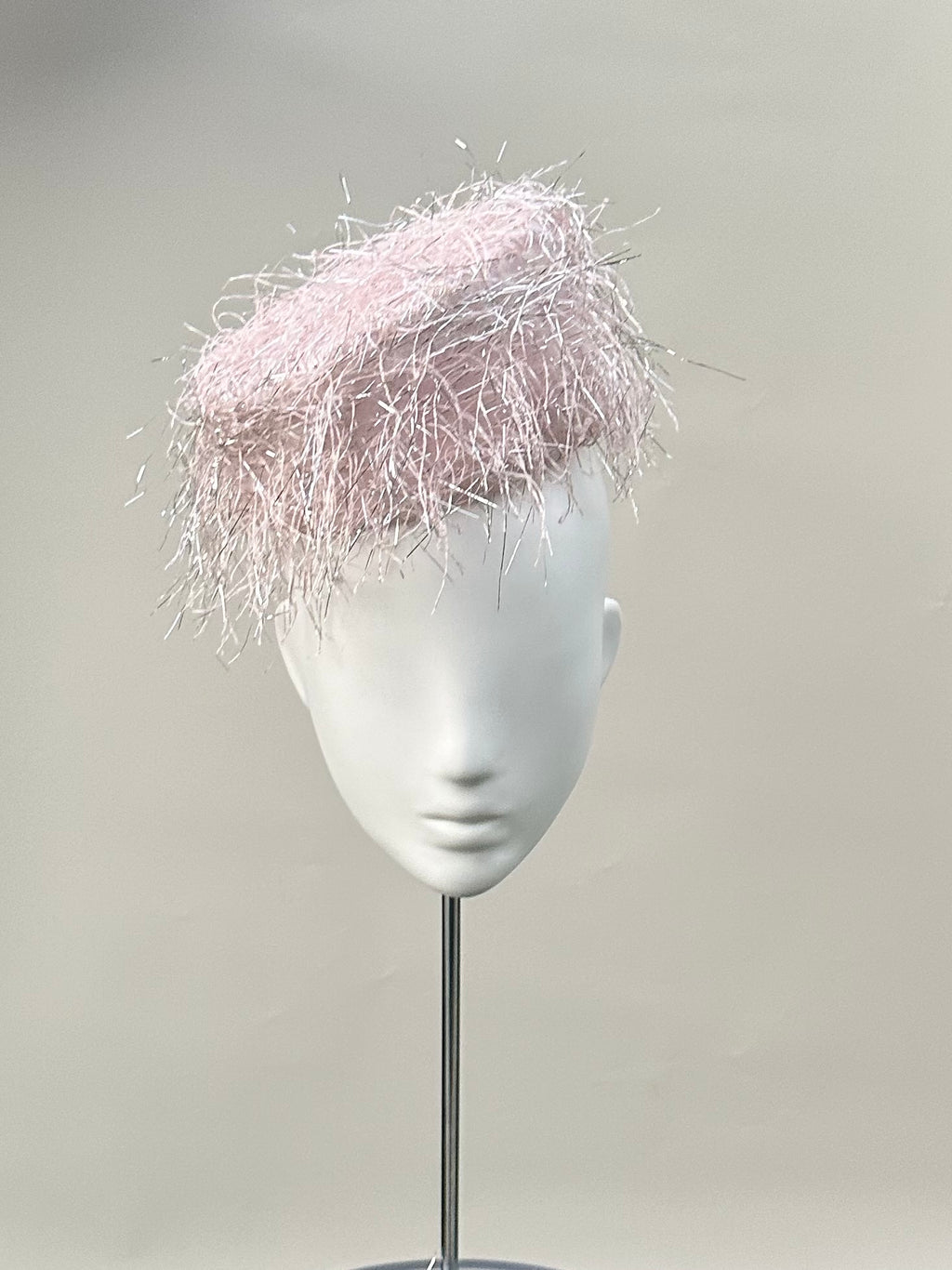 Frange di Luce blush pink pillbox hat with an angled silhouette and silver Lurex highlights
