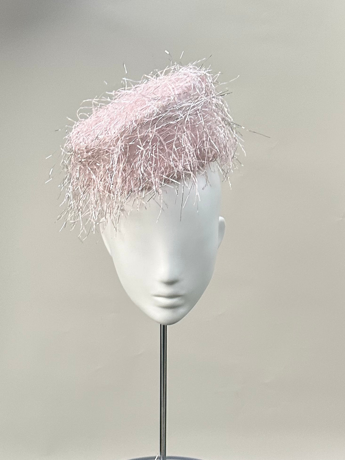 Frange di Luce blush pink pillbox hat with an angled silhouette and silver Lurex highlights