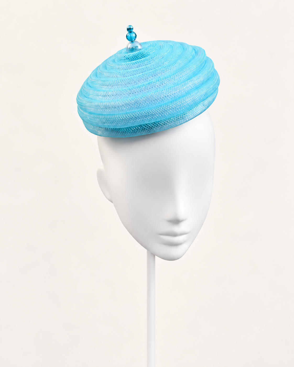Onda Azzurra — Aqua Sculptural Spiral Pillbox on a white mannequin and stand, view 1